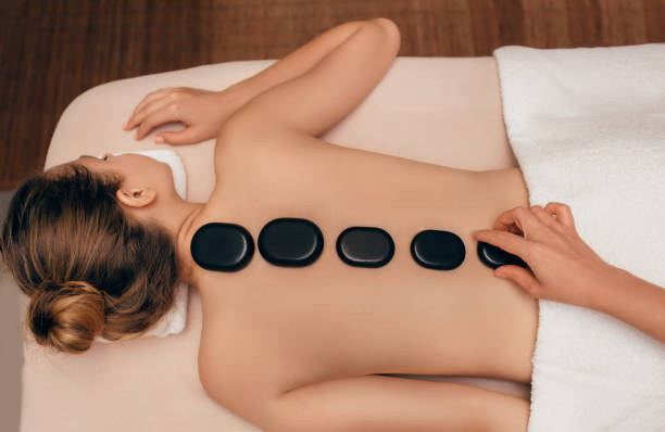 istock woman getting hot stone massage treatment 1007419956