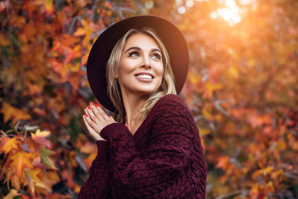 beautiful woman enjoying in a sunny autumn day - nature forest clothing smiling imagens e fotografias de stock