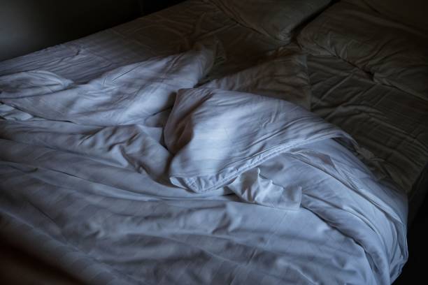 istock empty bed and unmade at the first light of dawn 1007422916