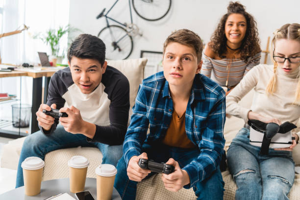 istock group of multiethnic teens playing video game at home 1007425160