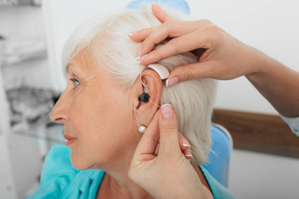 istock adjusting of a hearing aid for an elderly woman 1007426166