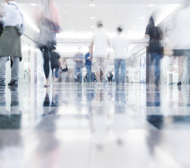 istock Motion blurred customers walking in shopping mall, Hong Kong 1007428666