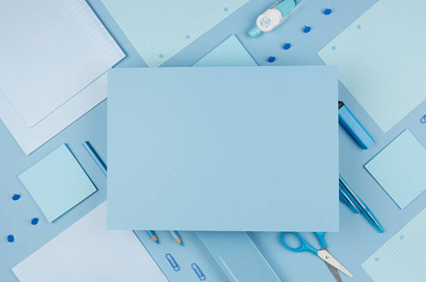 istock Back to school background - pink boy's different stationery set  and blank paper for text on soft blue paper background. 1007431360