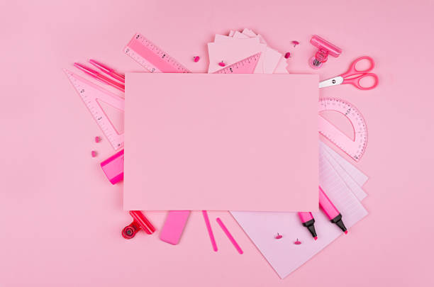 istock Different office supply and blank paper letterhead for text on pink color background, top view, copy space. 1007431528