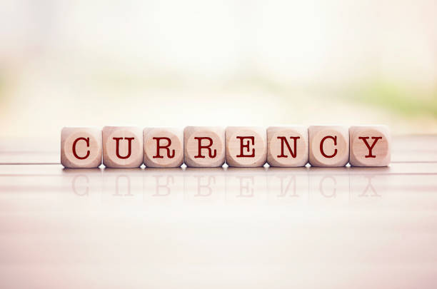 istock Currency word written on cube wooden blocks. 1007431546