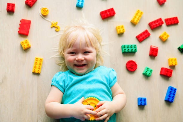 istock cute little girl play with plastic blocks 1007431598