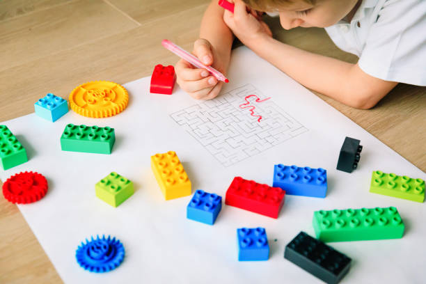 autims awareness- child solving labyrinth, mental health stock photo