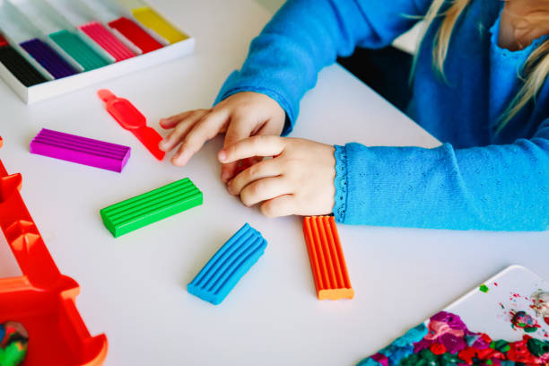 istock Child playing with clay molding shapes 1007438364