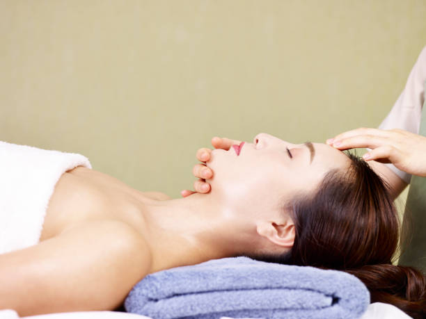 istock young asian woman enjoying a face massage 1007441256