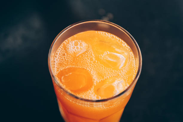 istock Orange drink with ice top view. 1007441556