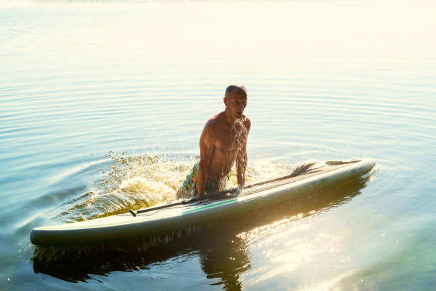 istock Joyful man is training on a SUP board and having fun 1007441560