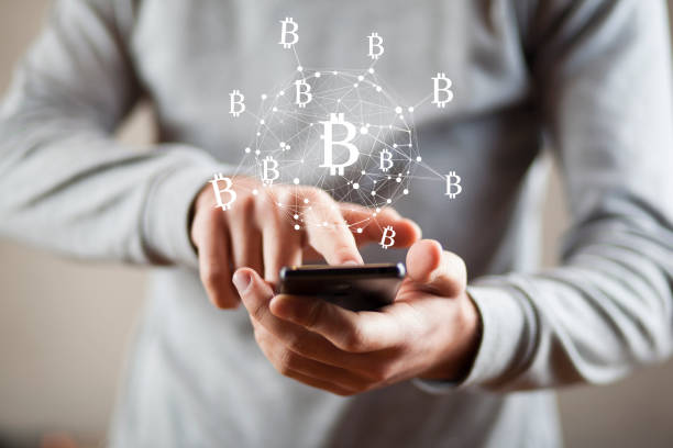 istock man hand smart  phone with bitcoin sign in screen 1007441730