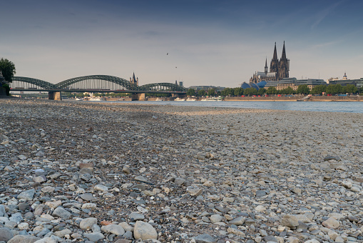 Cologne, Germany - July 20, 2018: Prolonged drought in Germany, low water of the Rhine river in Cologne at early morning time on July 20, 2018 in Germany