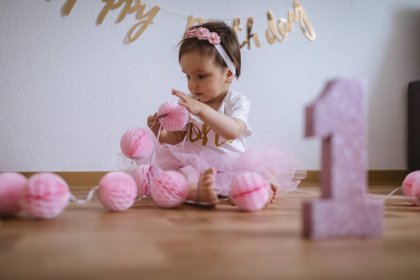 istock Cute and innocent baby playing on her first birthday 1007441890