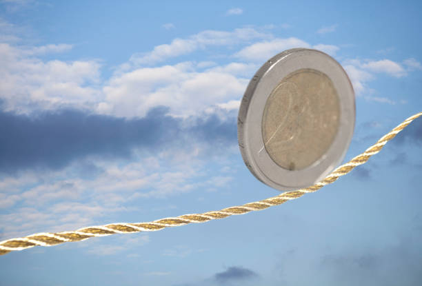 istock 2 Euro coin balancing on golden rope 1007442226