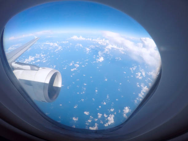 istock Passenger view through the window of a jet plane showing sky, clouds, jet engine and wing 1007444660
