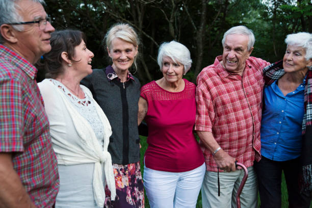 istock Group of seniors having fun taking a walk outdoors at dusk. 1007444928