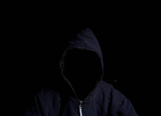 istock Anonymous criminal man in hood 1007445274