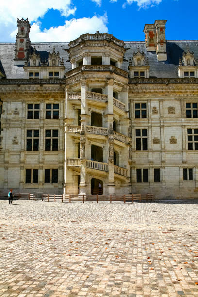 The decorative staircase of Blois Castle is seen from the side of the courtyard Blois, France - June 11, 2010: The decorative staircase of Blois Castle is seen from the side of the courtyard. Blois Royal Castle is a historical monument, which is a wonderful mixture of art and history. The walls and furnishings of this magnificent building are associated with seven kings and ten queens of France. This building, built over the centuries from the 13th to the 17th century, is now an excellent example of French architecture, with noticeable many styles that have changed over the centuries. blois stock pictures, royalty-free photos & images