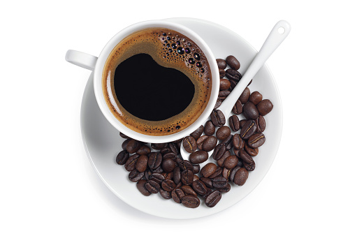 Cup of coffee and beans on white background, top view