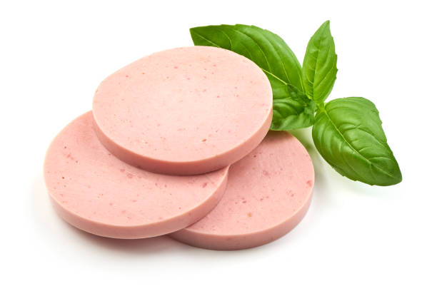 istock Salami sausage slices with basil, isolated on white background. 1007455194