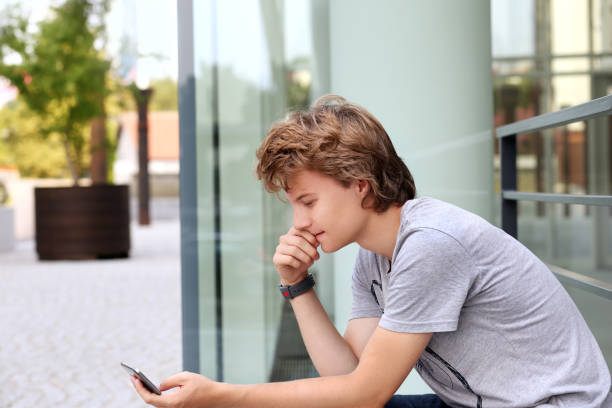 istock Using smart phone.Teenage boy typing text message. 1007455240