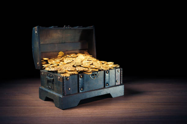 istock Treasure chest filled with gold coins 1007461100