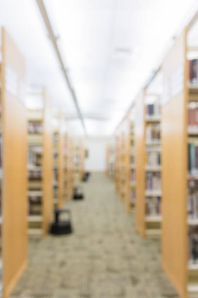 istock Blurred public library aisle of bookshelves background 1007461142