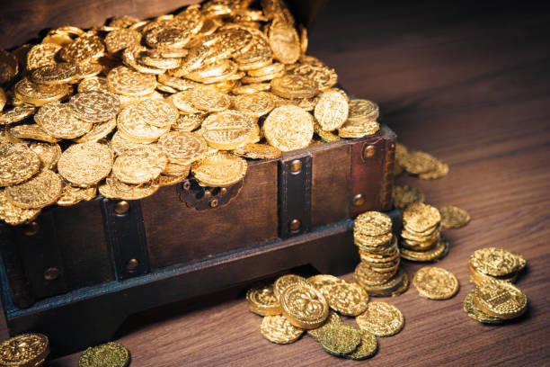istock Treasure chest filled with gold coins 1007461354
