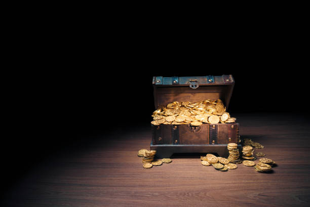 istock Treasure chest filled with gold coins 1007461416