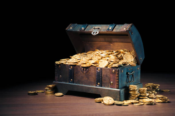 Treasure chest filled with gold coins stock photo