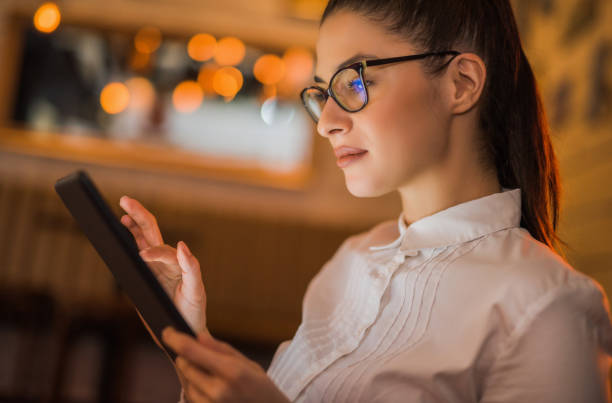 istock Beautiful young woman freelancing on her tablet. 1007465086