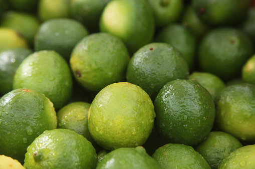 fresh green limes on the fruit market. close-up photo