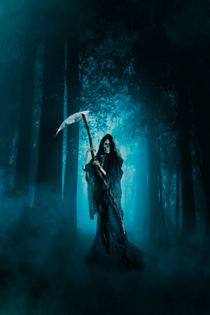 istock Grim reaper with a scythe in the woods 1007467556