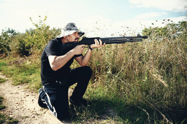 istock Male hunter aiming his rifle and preparing to shoot 1007477416