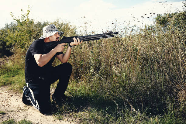 istock Male hunter aiming his rifle and preparing to shoot 1007477418