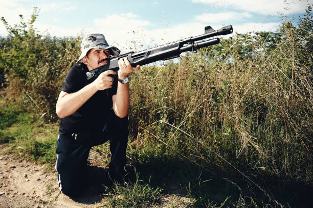 istock Male hunter aiming his rifle and preparing to shoot 1007477652
