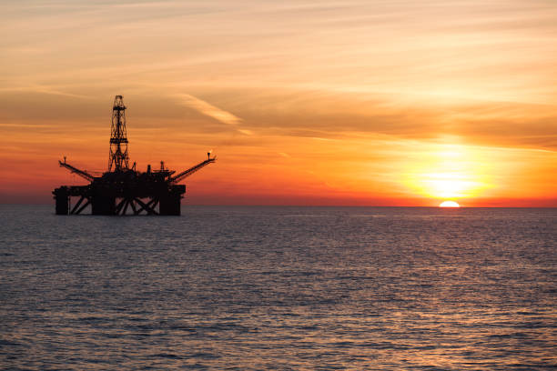 Offshore drilling rig at sunset stock photo