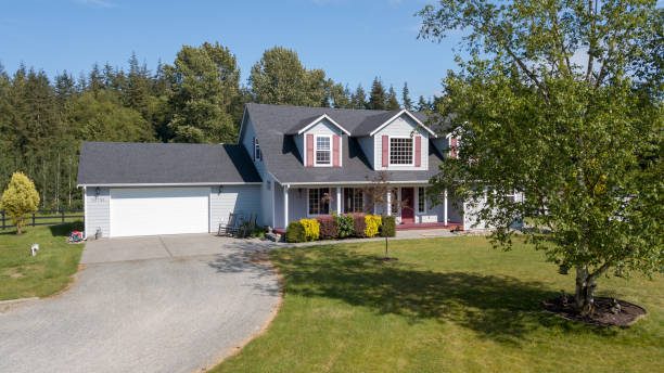 istock Cute home exterior with red shutters on a summer day. 1007485224