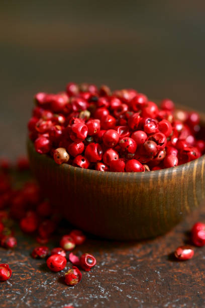 istock Rose pepper in a wooden bowl 1007485664