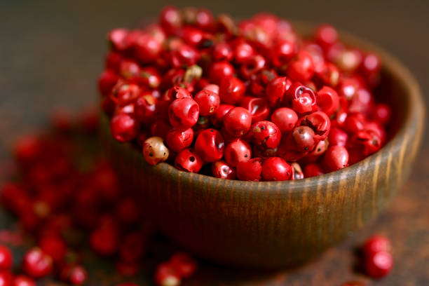 istock Rose pepper in a wooden bowl 1007485682
