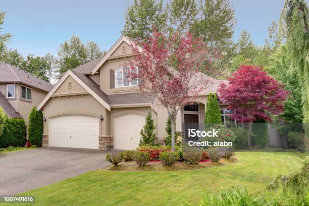 Exterior Of A Lovely House With Well Kept Front Yard Stock Photo - Download Image Now