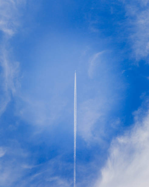 istock Jet in Sky With Vapor Trail (Vertical) 1007500734