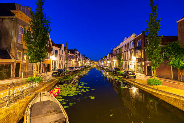 Street view on canals and monumental houses in historical city Gouda, the Netherlands Street view on canals and monumental houses in historical city Gouda, the Netherlands during dusk gouda south holland stock pictures, royalty-free photos & images