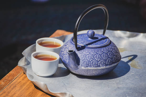 istock Ornate Tea Kettle and Tea Cups on a Table 1007504458