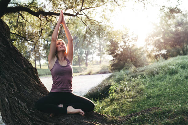istock Meditation by the river, in sunset 1007504660