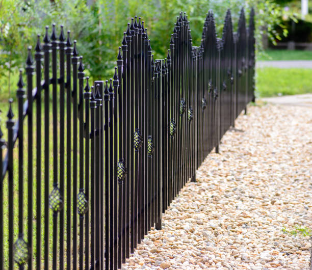 istock Black decorative metal fence, angular iron rods and curved upper part. 1007511142