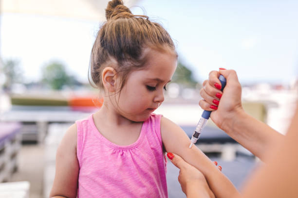 mignon enfant tenant une insuline tournée - insulin diabetes pen injecting photos et images de collection