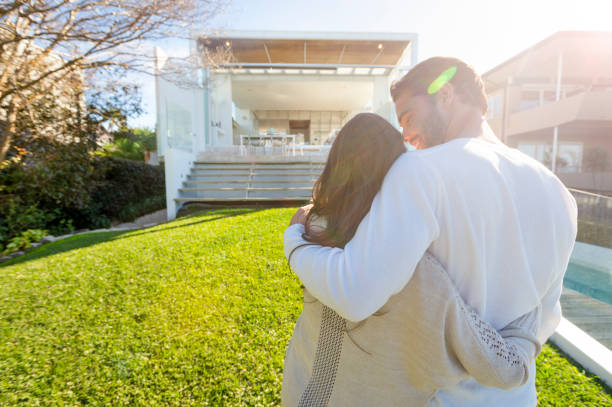 istock Young Couple standing in front of a modern new house. 1007514092