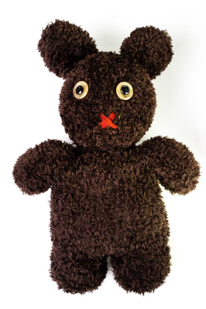 istock Handcraft fluffy brown yarn mixed between bear and bunny doll on isolated white background, pity eyes with red muted mouth 1007519358